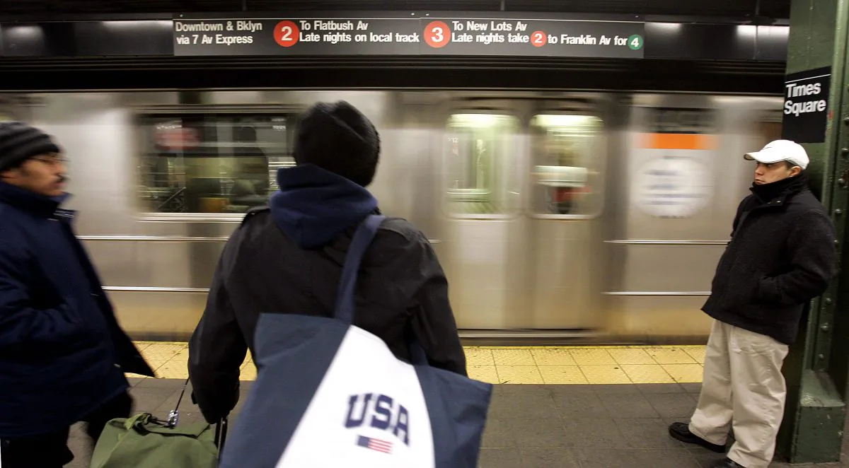 Commuters on a subway platform at Times Square in New York, December 23, 2005. (Stephen Chernin/Getty Images)