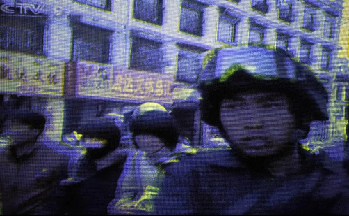 A frame grab taken from China's state television CCTV shows armed soldiers on a street in the Tibetan capital Lhasa, on March 16, 2008, a few months before the Beijing Olympics. Tibetan groups report that the Chinese regime violently cracked down on protests throughout Tibet at that time, resulting in an unknown number of deaths and disappearances. (AFP/AFP/Getty Images)
