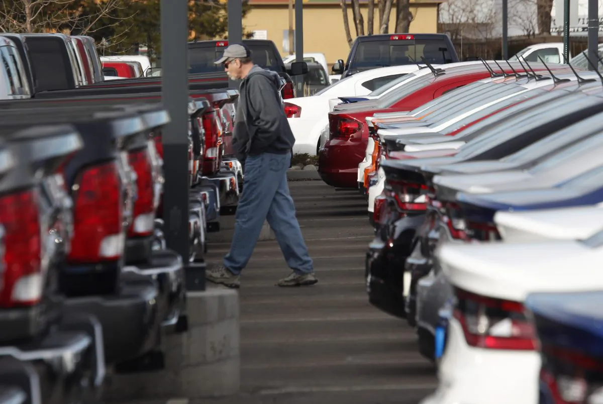 In this Sunday, Jan. 20, 2013, file photo, a buyer moves between rows of Ram pickup trucks and Dart sedans at a Dodge dealership in Littleton, Colo. Chrysler says its U.S. sales rose 8 percent in January 2014, as it posted strong growth despite the frigid weather that gripped much of the nation. (AP Photo/David Zalubowski, File)