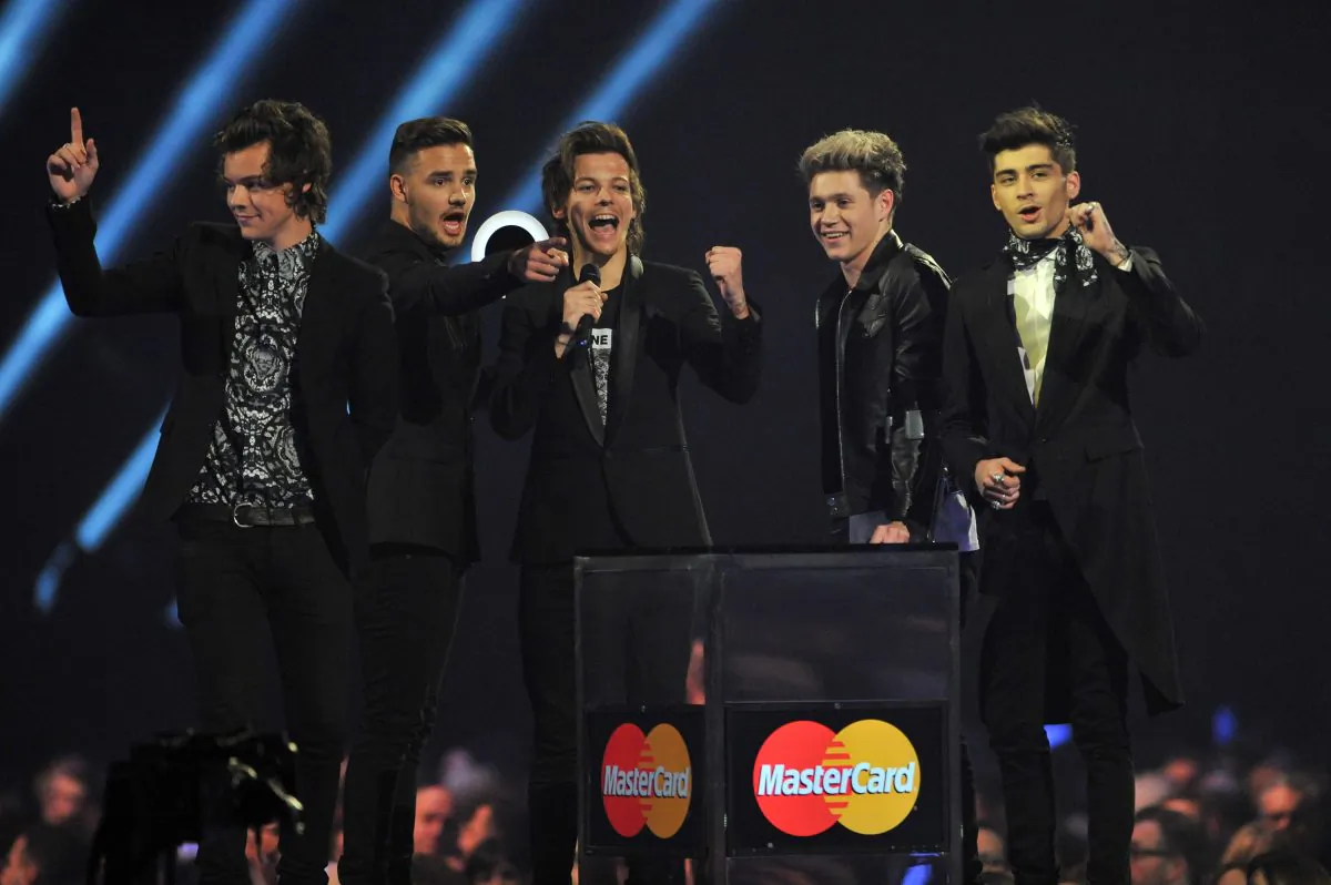 One Direction band members, from left Harry Styles, Liam Payne, Louis Tomlinson, Niall Horan and Zayn Malik accept the Best Video Award onstage at the BRIT Awards 2014 at the O2 Arena in London on Wednesday, Feb. 19, 2014. (Jon Furniss/Invision/AP)