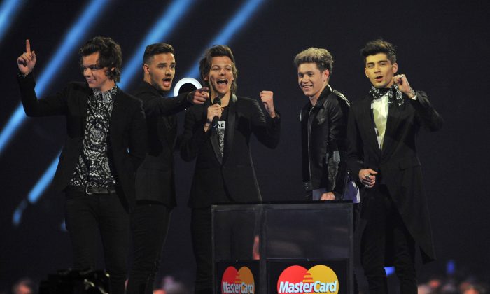 One Direction band members, from left Harry Styles, Liam Payne, Louis Tomlinson, Niall Horan and Zayn Malik accept the Best Video Award onstage at the BRIT Awards 2014 at the O2 Arena in London on Wednesday, Feb. 19, 2014. (Jon Furniss/Invision/AP)