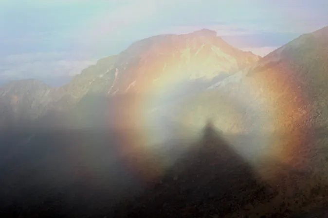 Brocken spectre on Mount Ontake, in Nagano Prefecture, Japan. Brocken spectres are shadows surrounded by rainbow light that appear hauntingly in the mountains. Learn more about them below. (Wikimedia Commons)