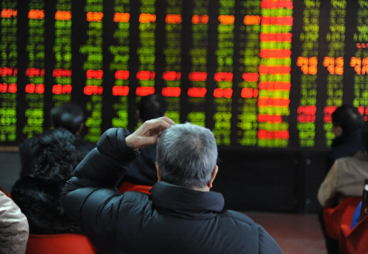 An investor scratches his head while watching the electronic board at a stock exchange hall in Shenyang, China on Feb. 19, 2013. Financial analysts are concerned about China's growing credit bubble. (ChinaFotoPress/Getty Images)