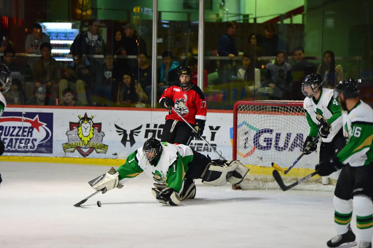 Macau Aces’ Goalie Loron Orris claims the puck during their CIHL match against Kowloon Warriors at Mega Ice on Saturday Feb 15, 2014. Although a relaxed Aces outfit have a clear lead at the top of the standings at the end of the season before playoffs begin, Warriors dominated and went on to win the match 10-1. (Bill Cox/Epoch Times)