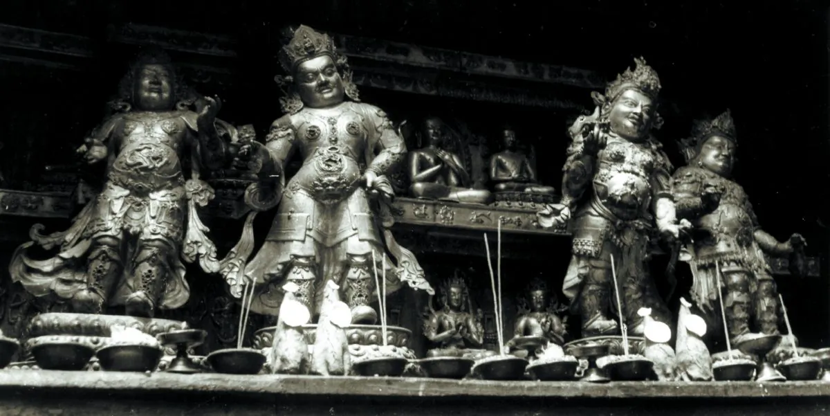 A tashi gomang stupa at Densatil showing the Tier of Buddhas and the Tier of Offering Goddesses behind the guardians for the four directions. 
(Photo by Pietro Francesco Mele, 1948, courtesy of Ulrich von Schroeder)