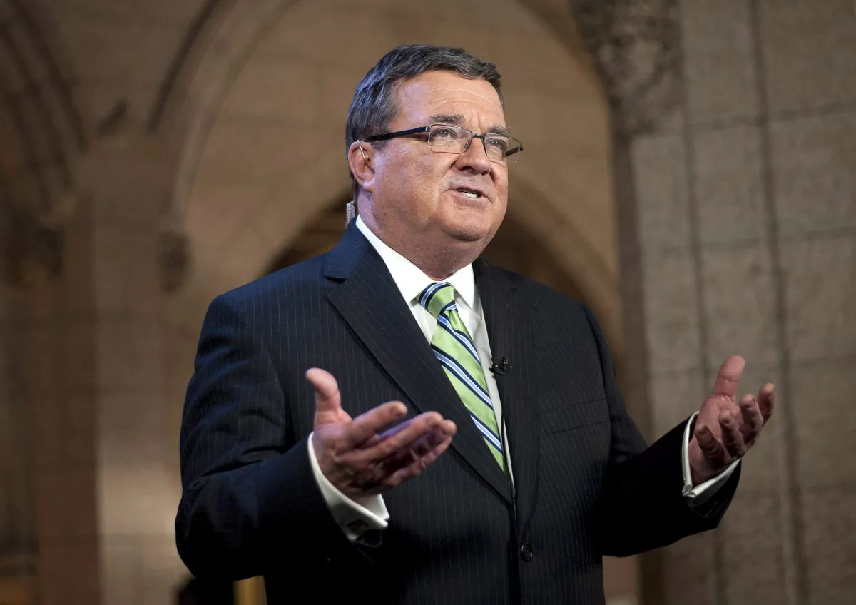 Former Finance minister Jim Flaherty speaks during a television interview after tabling the budget on Feb. 11, 2014. On Thursday Flaherty's family has said that the former Finance minister has died. He was 64.(The Canadian Press/Justin Tang)