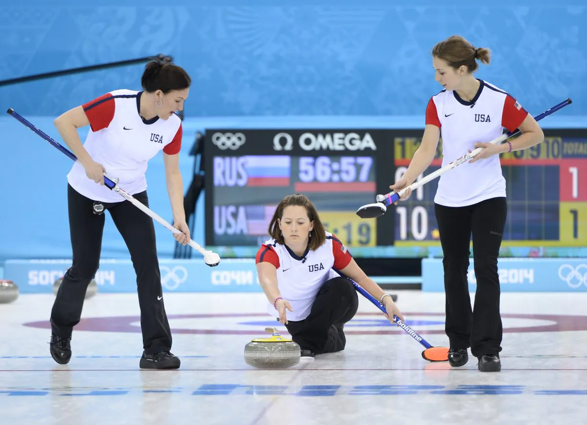 U.S. vice-skip Debbie McCormick (C) throws the stone during the women's curling round robin session 2 match between Russia and USA at the Ice Cube curling centre in Sochi on February 11, 2014 during the 2014 Sochi winter Olympics. (Jonathan Nackstrand/AFP/Getty Images)
