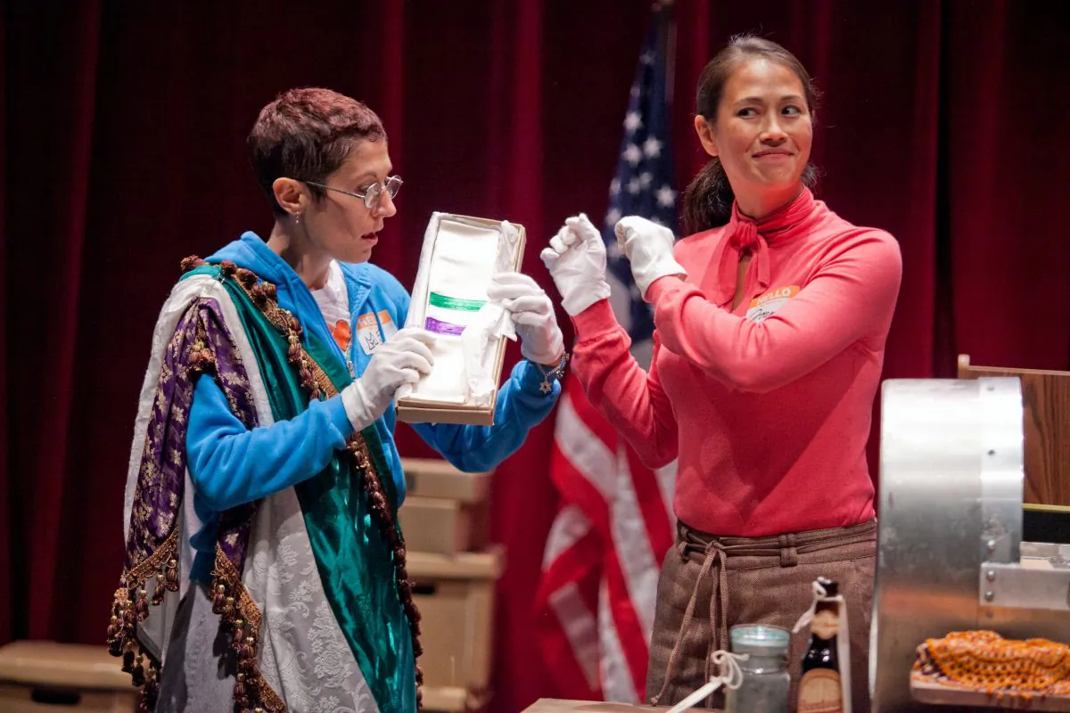 (L–R) Rachel Grossman and Elaine Yuko Qualter show artifacts from the time capsule. (C. Stanley Photography)