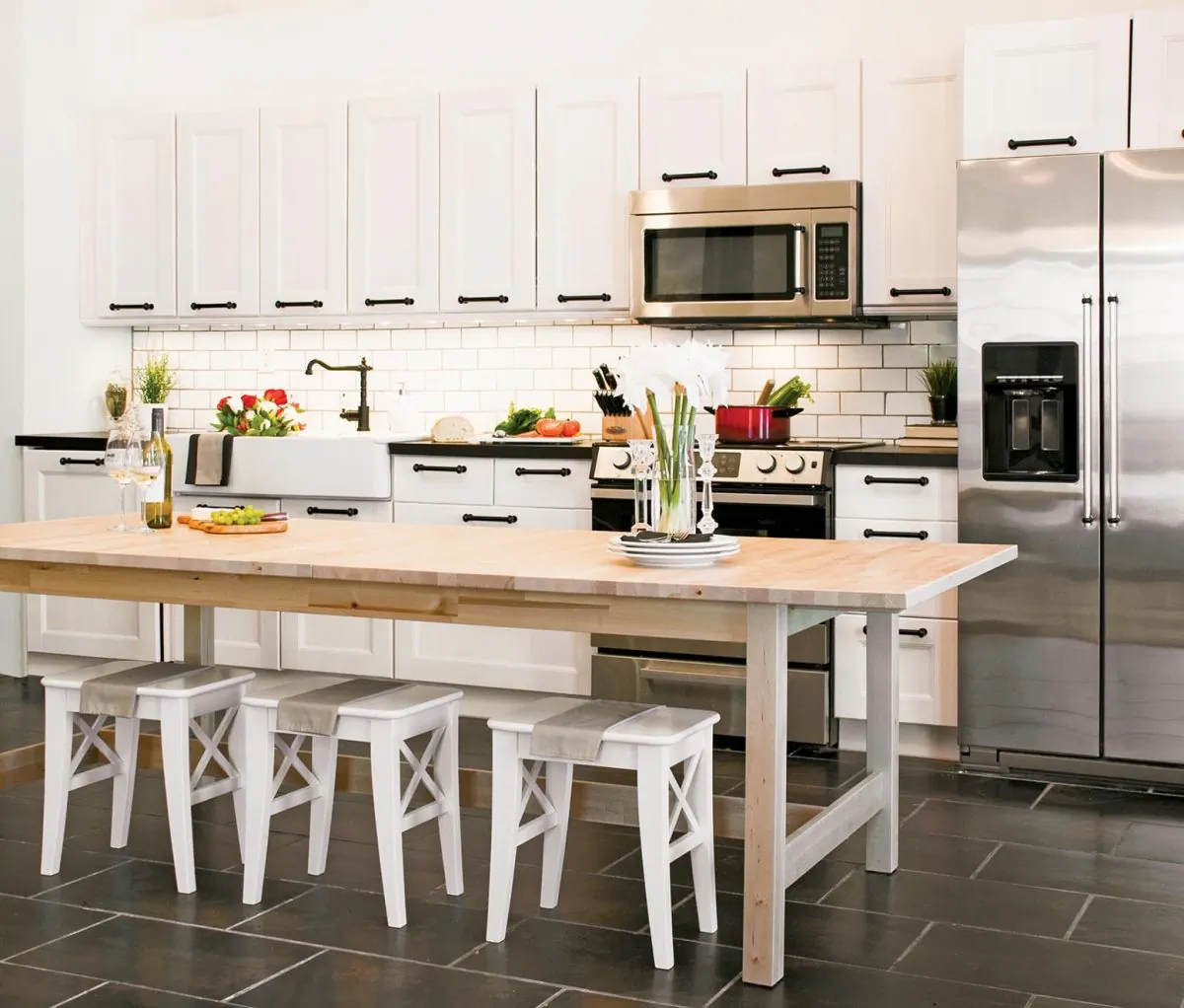A large table that extends to comfortably fit 12 guests can also act as an island, more than doubling counter space. (Brad McCann)