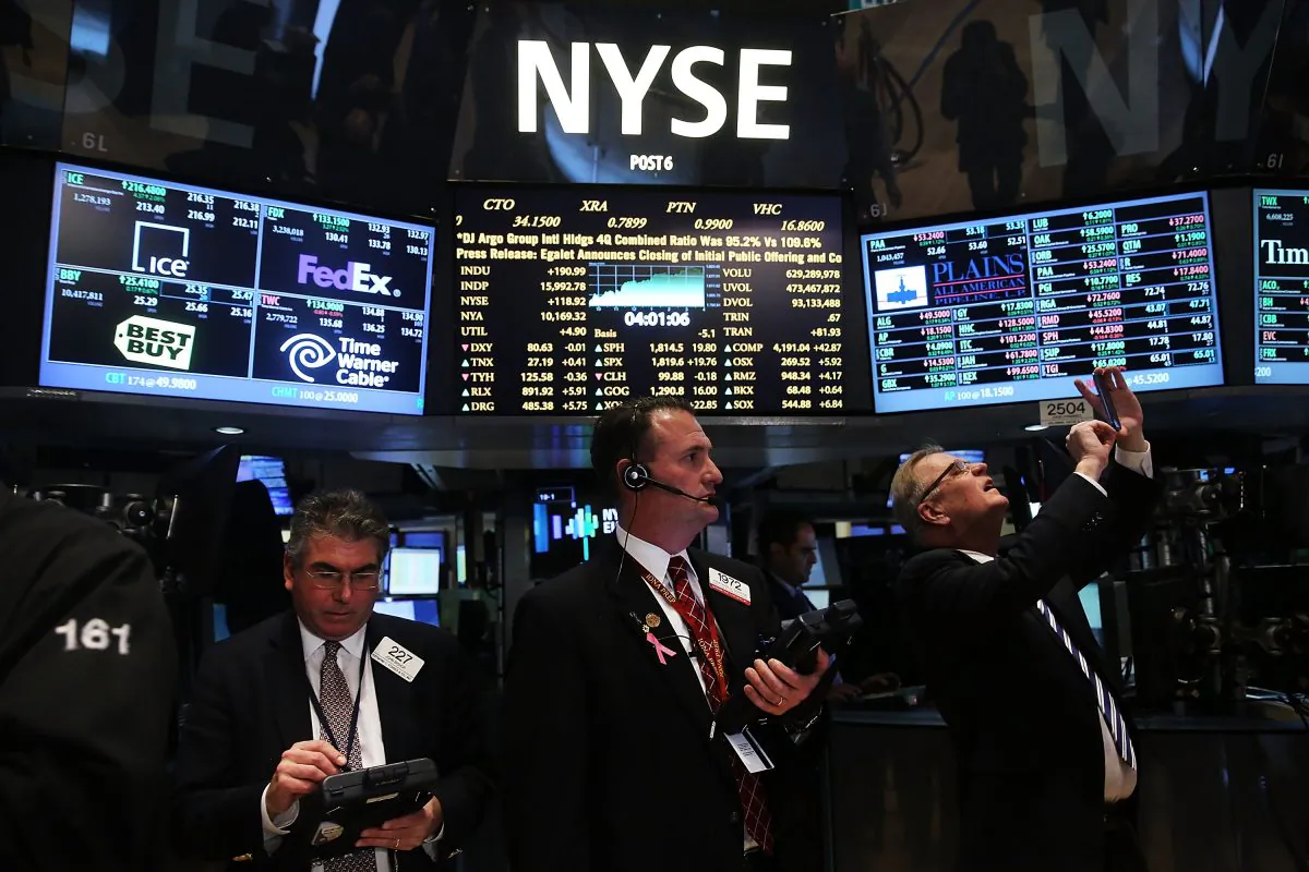 Traders on the floor of the New York Stock Exchange react to news on Feb. 11, 2014, that easy monetary policy will continue under new Fed chairwoman Janet Yellen. (Spencer Platt/Getty Images)