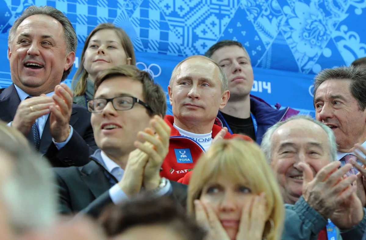 Russia’s President Vladimir Putin (C) watches the figure skating team free program during the Sochi Winter Olympics, Feb. 9, 2014. (Mikhail Klimentyev/AFP/Getty Images)
