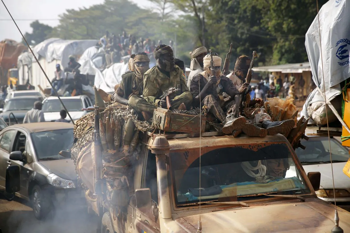 Chadian troops escort thousands of Muslim residents fleeing the Central African Republic capital of Bangui in a mass exodus using cars, pickups, trucks, and motorcycles, Feb. 7, 2014. (AP Photo/Jerome Delay)