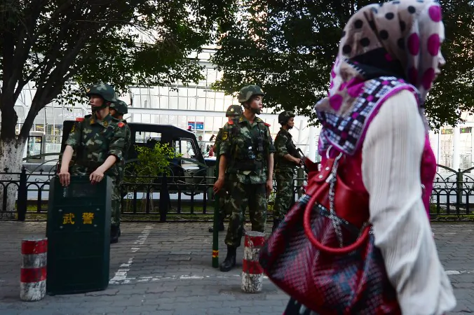 A new incident of violence in Xinjiang was the fault of religious extremists, says official media. Here Chinese paramilitary police stand guard in the Muslim Uighur minority area of Urumqi, Xinjiang Province on June 2013. The recent violence in Xinjiang is caused by ethnic grievances, according to experts, rather than the purported terrorism claimed by state-run media. (Mark Ralston/AFP/Getty Images)