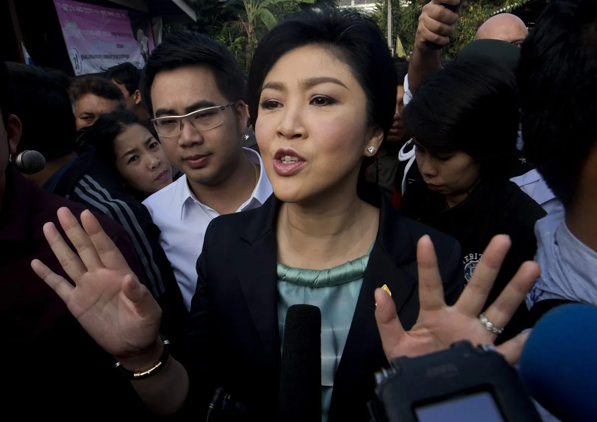 Thai Prime Minister Yingluck Shinawatra answers questions from the press after voting at a polling station in Bangkok on Feb 2. (Pornchai Kittiwongsakul/AFP/Getty Images)