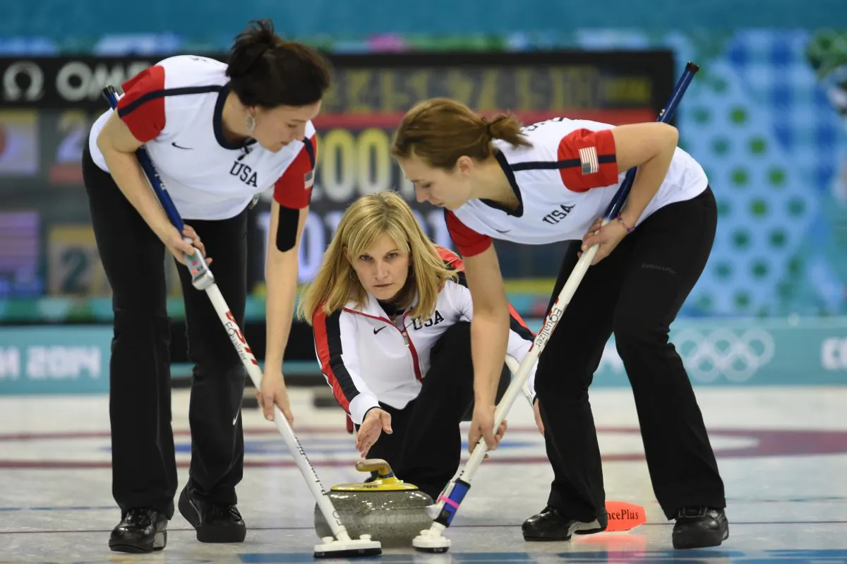 U.S. skip Erika Brown (C) throws the stone during the Women's Curling Round Robin Session 6 Japan vs USA at the Ice Cube Curling Center during the Sochi Winter Olympics on February 13, 2014. (Damien Meyer/AFP/Getty Images)