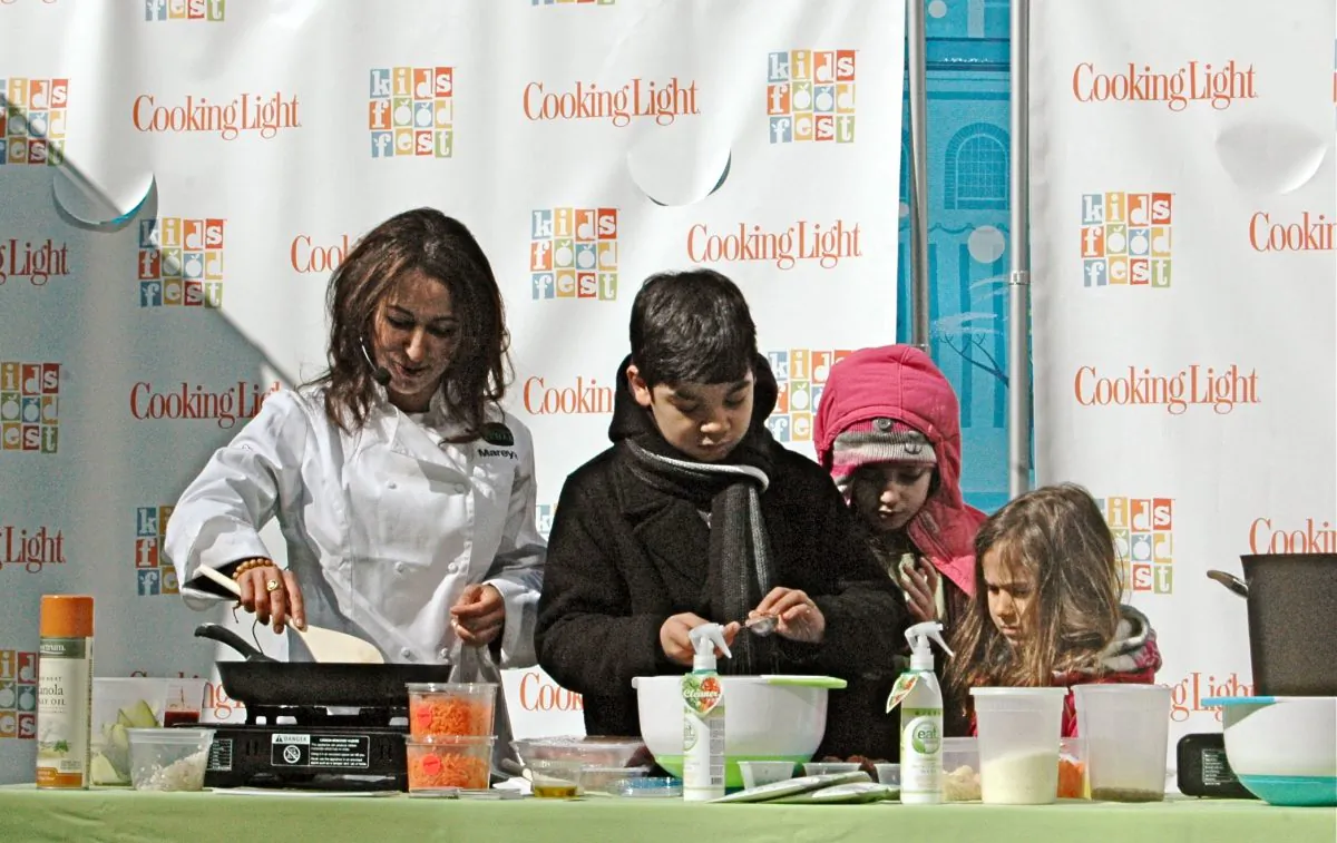 Mareya Ibrahim, known as the "Fit Foodie," cooks up a healthier spaghetti and meatballs with her young helpers in Bryant Park on March 2013. She brought a creative, unexpected twist to the classic kids' dish. (Channaly Philipp/Epoch Times)