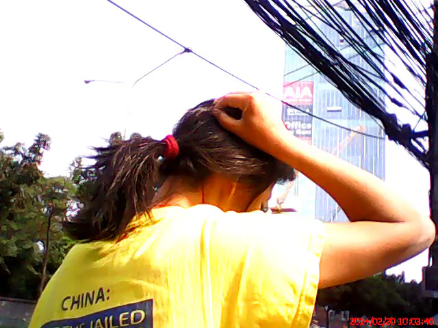 Blood trickles down Jane Kosinski’s head after she was forcefully pushed to the ground by men disrupting a peaceful protest outside the Chinese embassy in Bangkok, Feb. 20, 2014. (Epoch Times)