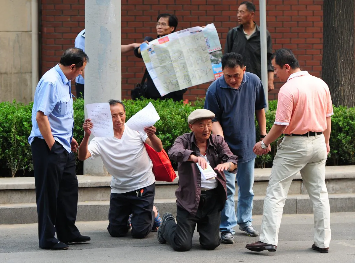 Elderly petitioners protesting medical access and land grab issues are detained by police in Beijing on May 10, 2012. New regulations that restrict petitioners have not been well received. (Mark Ralston/AFP/Getty Images)