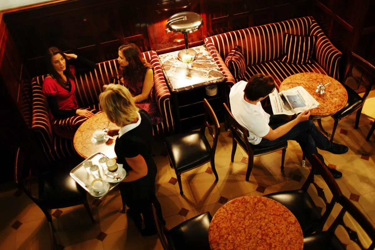 People relaxing at Vienna's Café Demel. Viennese coffeehouses are a good place to read, study, socialize, or spend some alone time. (Wien Tourismus/Peter Rigaud)