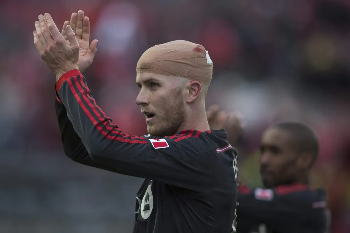 Toronto FC 's Michael Bradley (L) applauds supporters after their team's 1–0 win over D.C.United in MLS action in Toronto on Mar, 22, 2014. THE CANADIAN PRESS/Chris Young