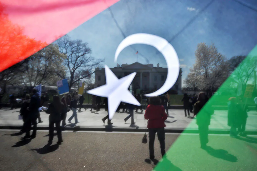 A man waves a Kingdom of Libya flag during an anti-war demonstration in front of the White House in Washington, DC, on March 26, 2011 urging an end to the war on Libya. (Jewel Samad/AFP/Getty Images)
