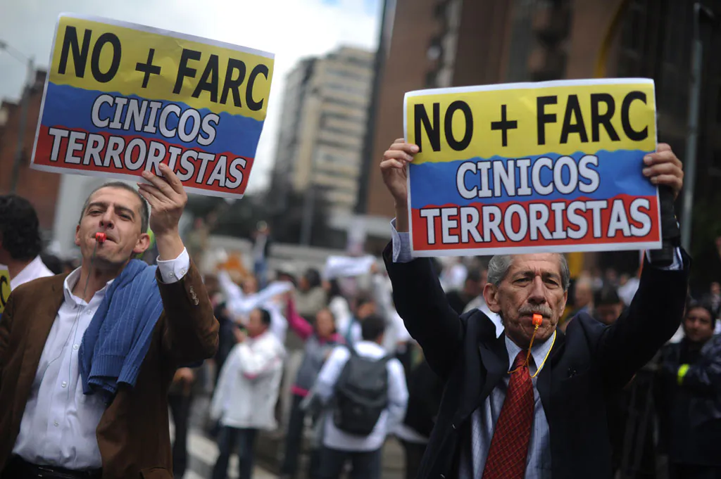 Colombians protest in Bogota, on December 6, 2011, against the left-wing FARC narcoguerrilla and their killing of hostages during a recent firefight with governmental forces. The placards read 'No More FARC', 'Cynical Terrorists'. (Eitan Abramovich/AFP/Getty Images)