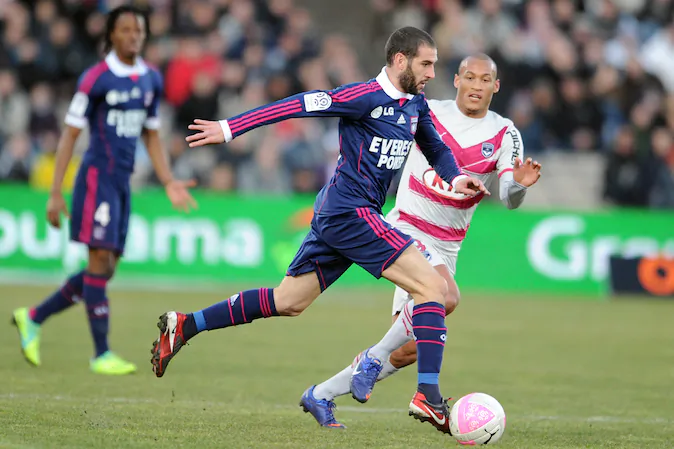 Bordeaux forward Yoan Gouffran (R) fights for the ball with Lyon's forward Lisandro Lopez (L)  during the French L1 football match Bordeaux vs Lyon on Feb. 19, 2012 at the Chaban Delmas stadium in Bordeaux. (NICOLAS TUCAT/AFP/Getty Images)