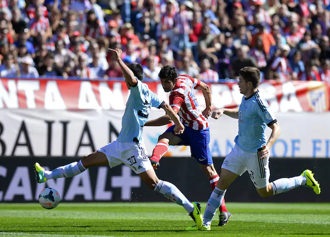 Atletico Madrid's Brazilian forward Diego da Silva Costa (C) vies with Celta's defender David Costas (L) and Celta's defender Andreu Fontas during the Spanish league football match Club Atletico de Madrid vs RC Celta de Vigo at the Vicente Calderon stadium in Madrid on October 6, 2013. AFP PHOTO/ PIERRE-PHILIPPE MARCOU (Photo credit should read PIERRE-PHILIPPE MARCOU/AFP/Getty Images)
