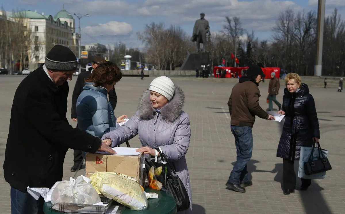 Pro Russia activists gather signatures for a referendum on secession for the Donetsk region at a central square in Donetsk, eastern Ukraine, Wednesday, March 12, 2014. The Group of 7 world leaders said in a statement released from the White House on Wednesday that they won't recognize results of a referendum for the Crimea region to split from Ukraine and join Russia. (AP Photo/Sergei Grits)