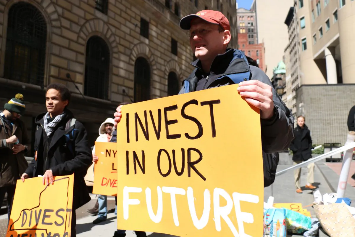 Participants in front of the state comptroller's Manhattan office call for pension fund's divestment of fossil fuel companies, in New York on March 27, 2014. (Allen Xie)