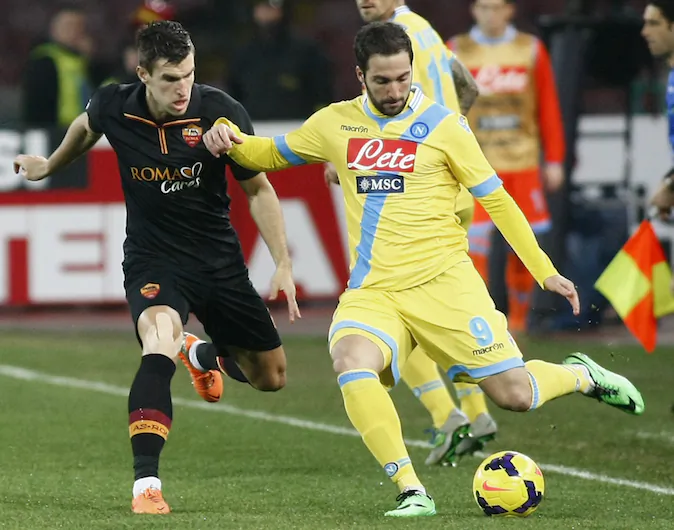 Napoli's Argentinian forward Gonzalo Higuain (R) fights for the ball with Roma's Dutch midfielder Kevin Strootman (L) during the Italian Cup semi-final second leg football match SSC Napoli vs AS Roma at the San Paolo Stadium in Naples, on Feb. 12, 2014. (CARLO HERMANN/AFP/Getty Images)