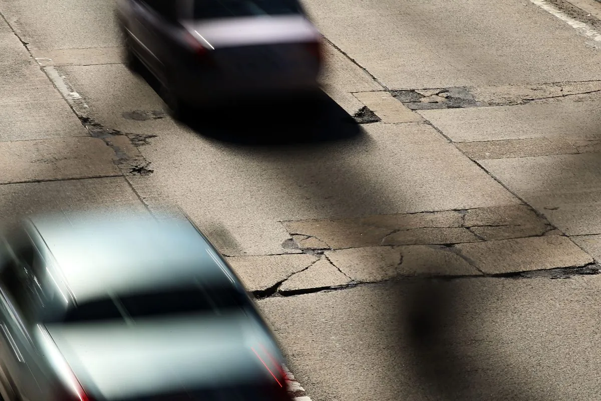 Cars travel over a section of highway riddled with potholes in Brooklyn, Feb. 24, 2014. (Spencer Platt/Getty Images)