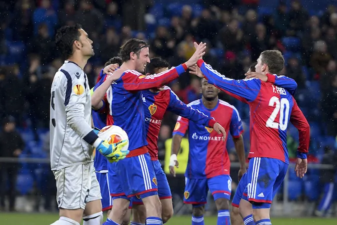 Basels players including team forward Marco Streller (2nd L) celebrate after their team's third goal as Tel-Aviv's Spanish goalkeeper Juan Pablo (L) looks on during the UEFA Europa League round of 32 second leg football match between FC Basel and Maccabi Tel Aviv FC on February 27, 2014 in Basel. (FABRICE COFFRINI/AFP/Getty Images)