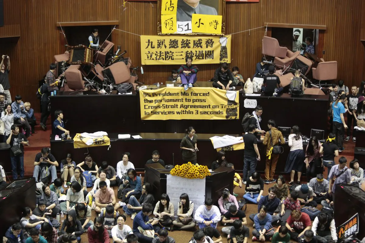 Students and protesters occupy the Taiwanese Parliament on March 19, in Taipei, Taiwan, to protest against the ruling Nationalist Party's attempt ratify a controversial service and trade agreement with China. Over 200 students broke into the Taiwan Parliament and took over the main chamber. (Ashley Pon/Getty Images)