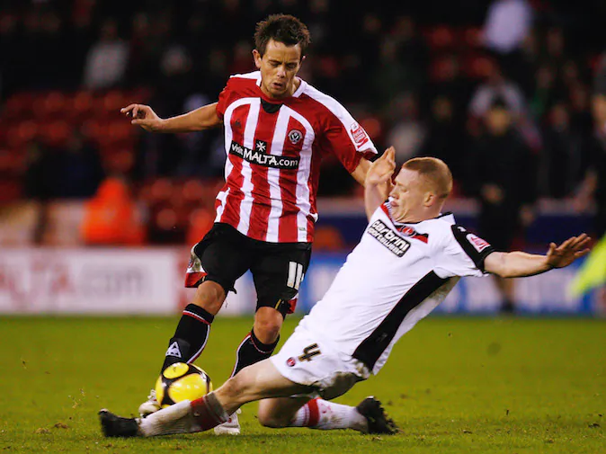SHEFFIELD, UNITED KINGDOM - JANUARY 24: Lee Hendrie of Sheffield United battles for the ball with Nicky Bailey of Charlton Athletic during the FA Cup Sponsored by E.on 4th Round match between Sheffield United and Charlton Athletic at Bramall Lane on January 24, 2009 in Sheffield, England. (Photo by Paul Gilham/Getty Images)