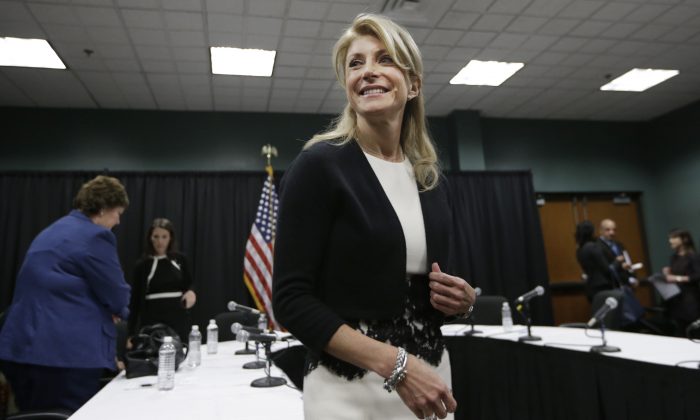 Former Texas Sen. Wendy Davis smiles as she heads to speak to reporters after an education roundtable meeting in Arlington, Texas on Jan. 9, 2014.  (LM Otero/AP Photo)