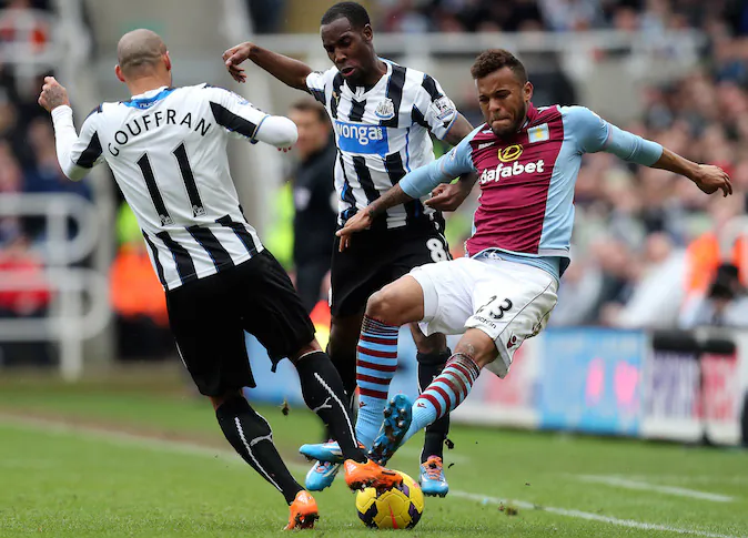 Aston Villa's Ryan Bertrand, right, vies for the ball with Newcastle United's Yoan Gouffran, left, and Vurnon Anita, center, during their English Premier League soccer match at St James' Park, Newcastle, England, Sunday, Feb. 23, 2014. (AP Photo/Scott Heppell)