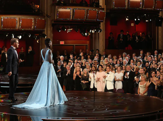 Lupita Nyong’o receives a standing ovation as she accepts the award for best actress in a supporting role for "12 Years a Slave" during the Oscars at the Dolby Theatre on Sunday, Mar. 2, 2014, in Los Angeles. (Photo by Matt Sayles/Invision/AP)