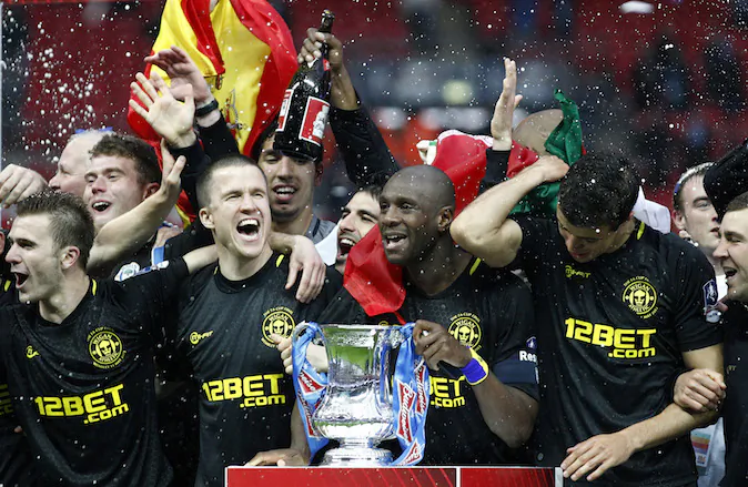 In this picture made available May 12 Wigan Athletic players including their captain Emmerson Boyce, centre right, celebrate after their 1-0 win over Manchester City in their English FA Cup final soccer match at Wembley Stadium, London, Sunday, May 12, 2013. (AP Photo/Jon Super)