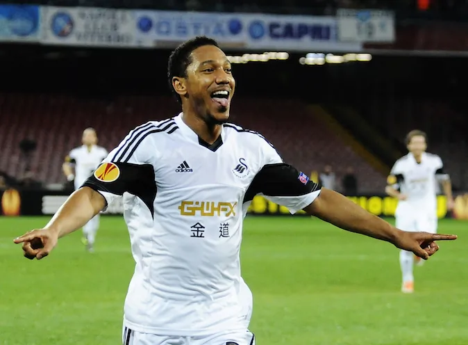 Swansea's Jonathan De Guzman celebrates after scoring during an Europe League, round of 32, second leg, soccer match between Napoli and Swansea, at the Naples San Paolo stadium, Italy, Thursday, Feb. 27,  2014. (AP Photo/Salvatore Laporta)