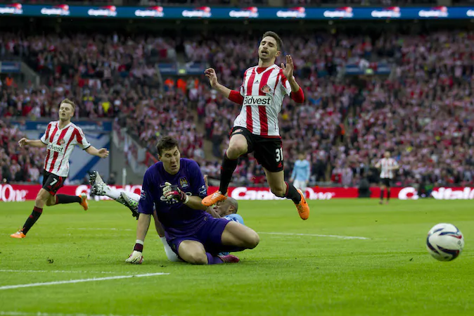 Sunderland's Fabio Borini, top, is thwarted by Manchester City's goalkeeper Costel Pantilimon during the League Cup Final at Wembley Stadium, London, England, Sunday Mar. 2, 2014. (AP Photo/Jon Super)
