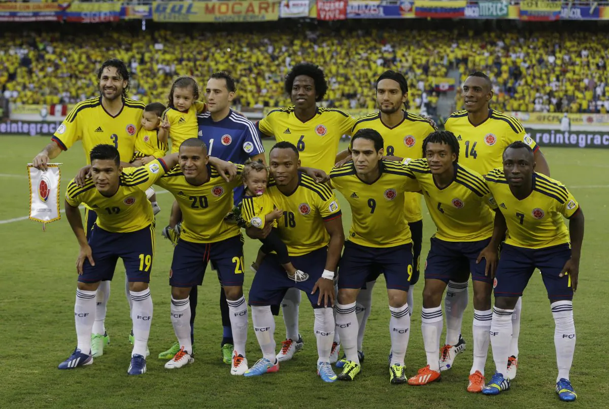 In this June 11, 2013 file photo, Colombia soccer national team pose prior to a 2014 World Cup qualifying match against Peru in Barranquilla, Colombia. Background from left: Mario Yepes, David Ospina, Carlos Sanchez, Abel Aguilar and Luis Perea. Foreground from left: Teofilo Gutierrez, Macnelly Torres, Camilo Zuniga, Radamel Falcao Garcia, Juan Cuadrado and Pablo Armero. The draw for the 2014 World Cup finals takes place Friday Dec. 6, 2013 near Salvador, Brazil. The 32 teams will be drawn into eight groups of four. The top two in each group will progress to the knockout stages. Twelve stadiums in twelve cities will host matches. (AP Photo/Ricardo Mazalan, File)