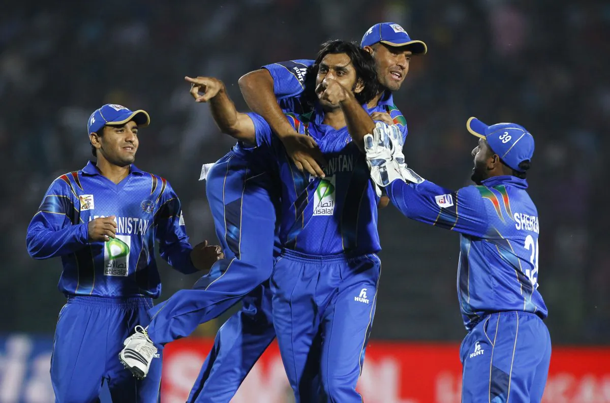 Afghanistan's Shapoor Zadran, center, and his teammates celebrate taking the wicket of Bangladeshs Shamsur Rahman during the Asia Cup one-day international cricket tournament in Fatullah, near Dhaka, Bangladesh, Saturday, March 1, 2014. (AP Photo/A.M. Ahad)
