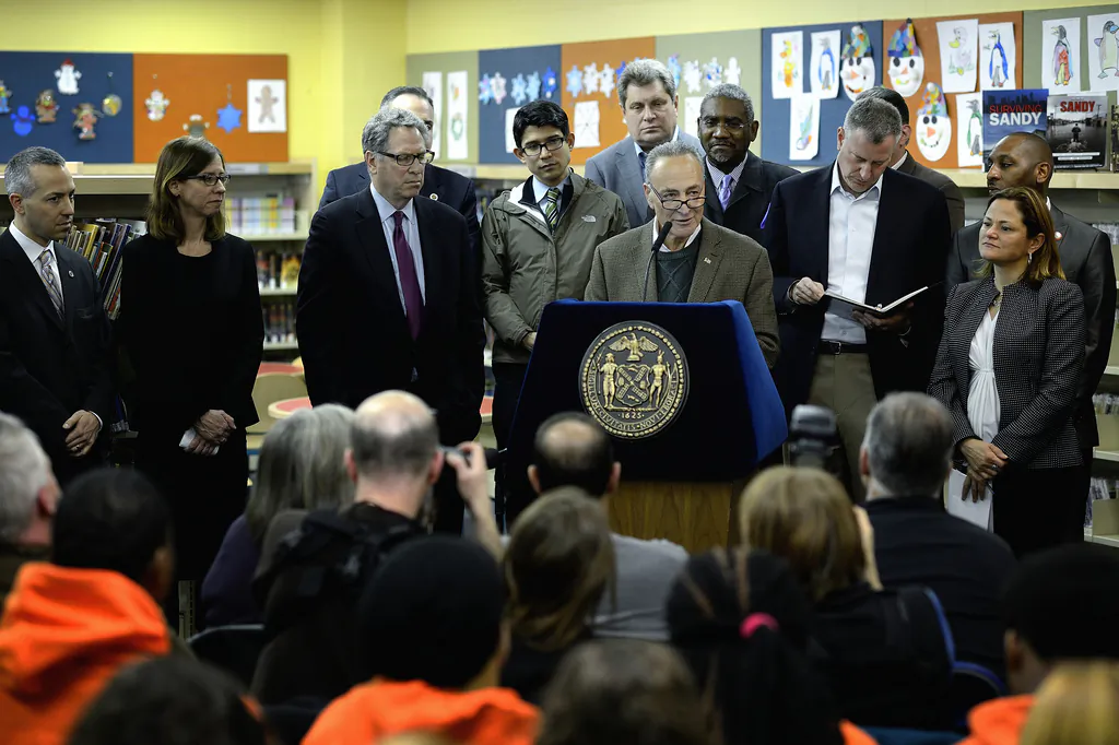 Sen. Charles Schumer speaks at a press conference announcing Mayor Bill de Blasio’s new Superstorm Sandy recovery leadership team in New York, March 29, 2014. (L-R) Daniel Zarrilli, director of new Office of Recovery and Resiliency; Amy Peterson, director of Housing Recovery Office, Bill Goldstein, senior advisor for Recovery, Resiliency, and Infrastructure. (Courtesy of Mayor Bill de Blasio's office)