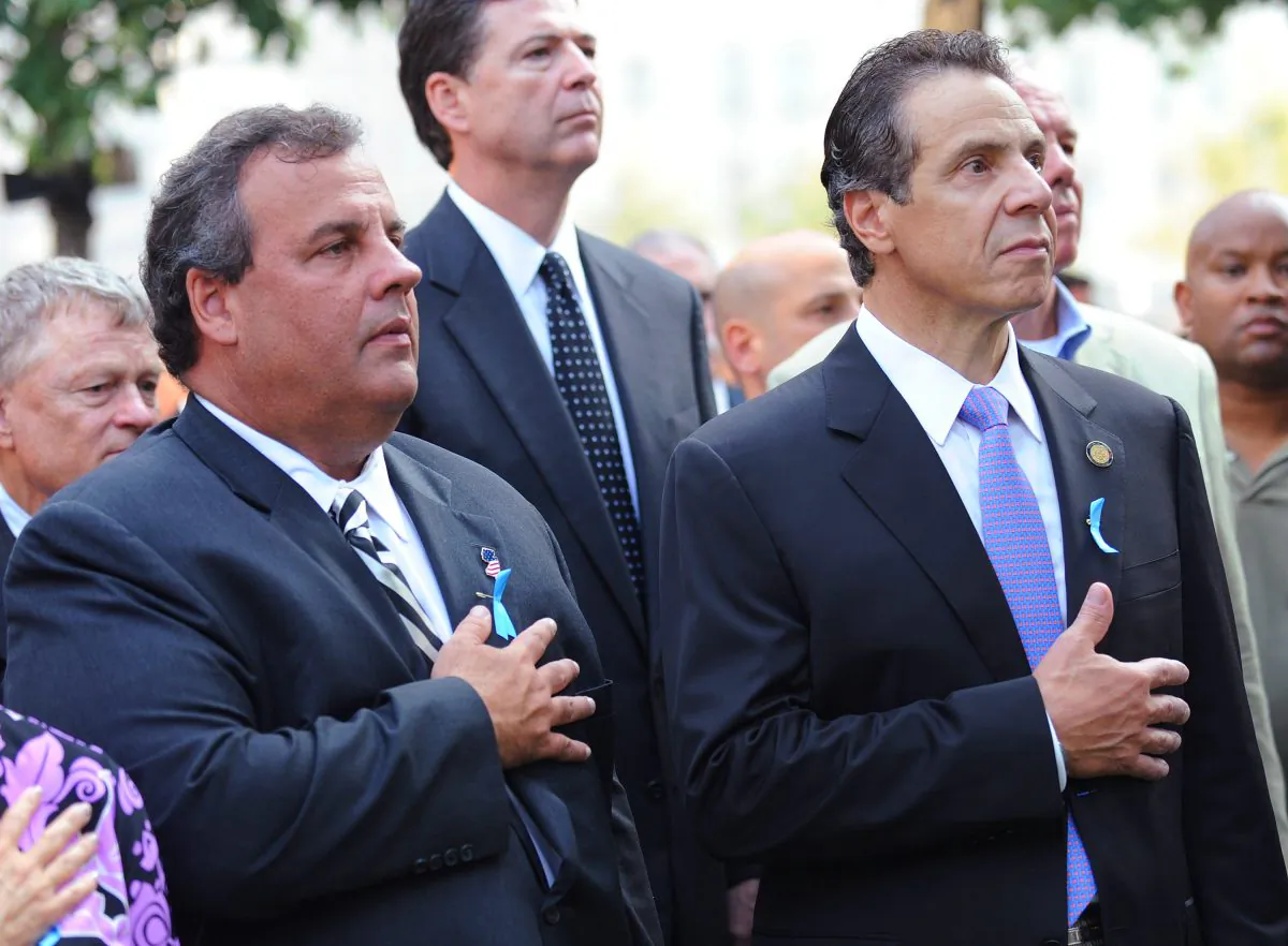 New Jersey Gov. Chris Christie (L) and New York Gov. Andrew Cuomo (R) hold their hands over their hearts at the 9/11 Memorial during ceremonies at the World Trade Center site in New York on Sept. 11, 2013. (David Handschuh /Getty Images)