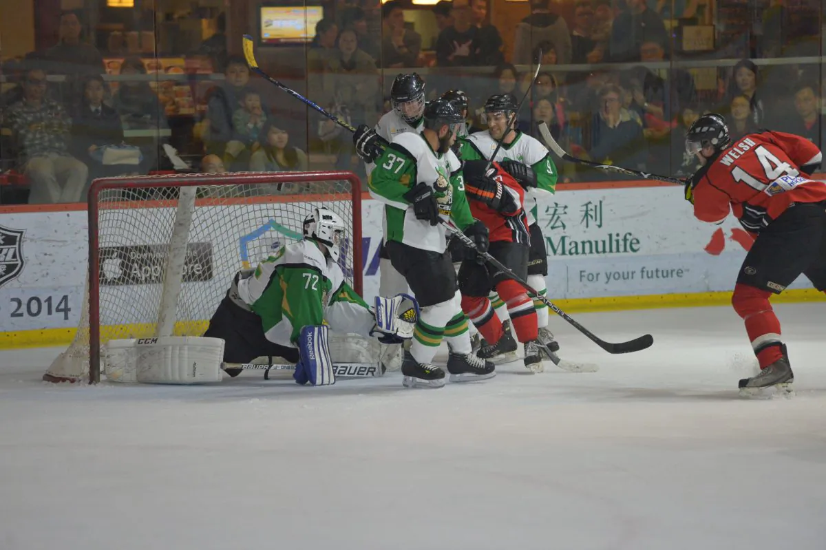 Devin Welsh of the Kowloon Warriors fired into the top of the net to take a 3-2 lead in the third minute of Period-2. Warriors defeated Macaus Aces 7-2 in the first round of best-of-three playoffs in the CIHL on Saturday Mar 1, 2014. (Patrick Calkins)