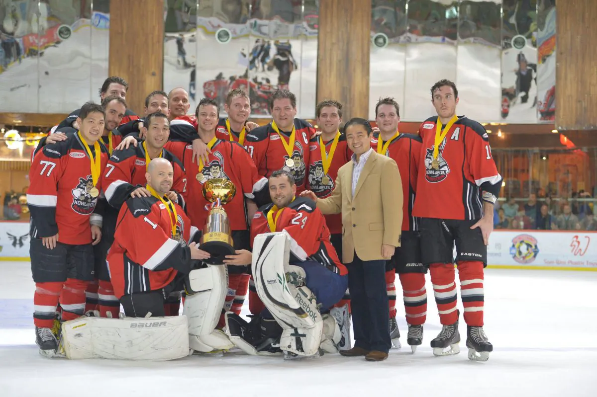 Michael Yong-Haron, representing title sponsors RBC, joins the Warriors team to celebrate their win in the CIHL Championship Final at Mega Ice on Saturday March 22, 2014. (Bill Cox/Epoch Times)