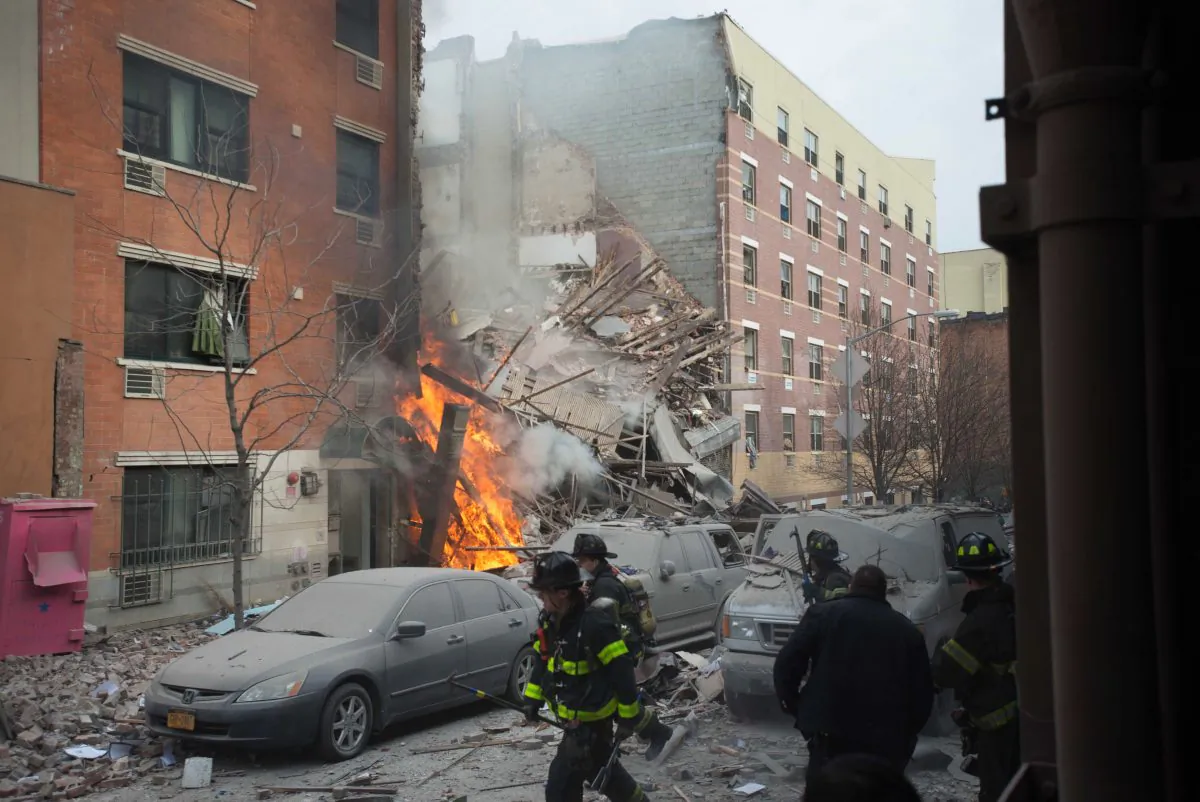 Firefighters work the scene of an explosion that leveled two apartment buildings in the East Harlem neighborhood of New York, Wednesday, March 12, 2014. (Jeremy Sailing/AP)
