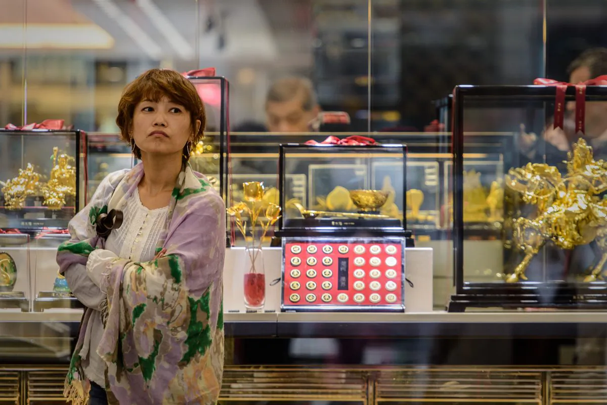 A woman looks on in front of a jewellery shop in Hong Kong on April 16, 2013. (PHILIPPE LOPEZ/AFP/Getty Images)