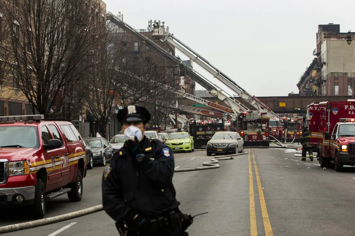 A police officer near the scene of a gas leak explosion that caused two buildings to collapse on Park Avenue and 116th street in the Harlem neighborhood of Manhattan March 12, 2014 in New York City. Reports of an explosion were heard before the collapse of two multiple-dwelling buildings that left at least 17 injured. (Christopher Gregory/Getty Images)